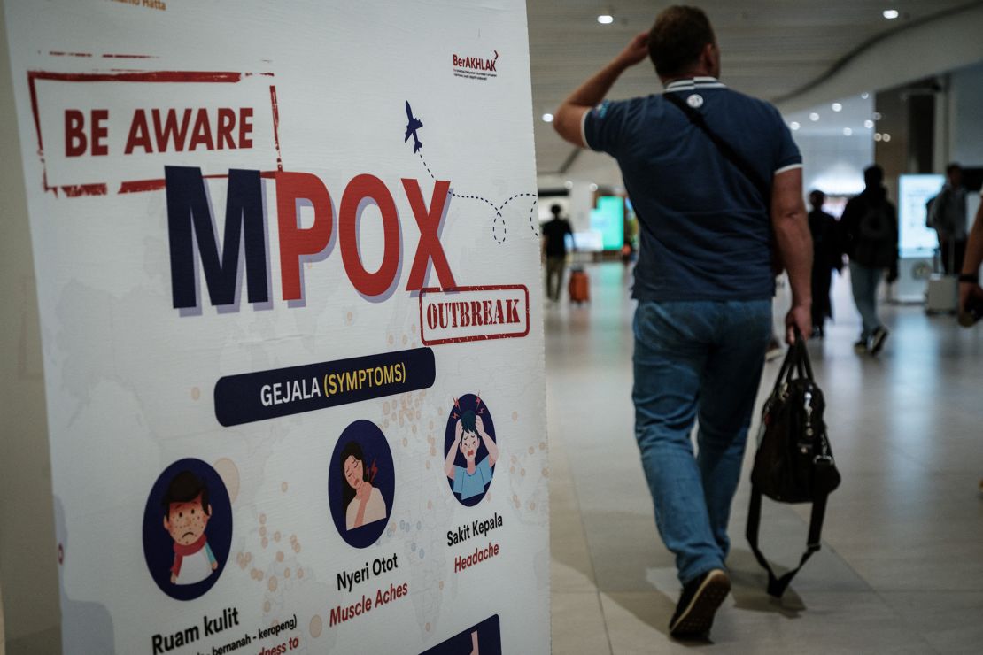 A passenger walks past a banner informing travelers about Monkeypox (MPOX) at Soekarno-Hatta International Airport in Tangerang, Indonesia on August 26, 2024.