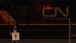 A Teamsters union member holds a picket sign at the entrance of CN Rail Lynn Creek Yard in North Vancouver, British Columbia, Canada on Wednesday.
