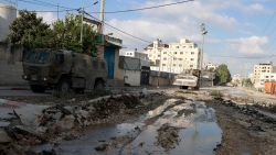 Israeli military vehicles drive down a road during a raid in northern city of Tulkarm in the occupied West Bank on August 28, 2024.