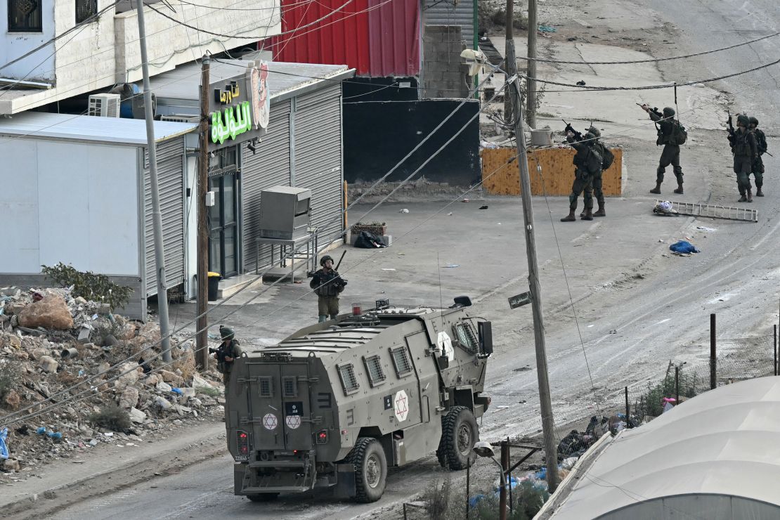 Israeli soldiers walk down a street during a raid in the al-Faraa camp for Palestinian refugees near Tubas city in the occupied West Bank on August 28, 2024.