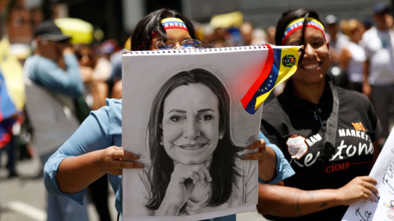 A woman holds a drawing of Venezuelan opposition leader Maria Corina Machado during a rally called by the ruling party in Caracas on August 28, 2024. The Venezuelan ruling party called for a mobilization on August 28, to 'celebrate' Maduro's victory, which has been rejected by the United States, the European Union and several countries in the region. (Photo by Pedro Rances Mattey / AFP) (Photo by PEDRO RANCES MATTEY/AFP via Getty Images)