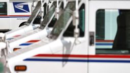 U.S. Postal Service trucks are parked at a post office in Glendale, California.