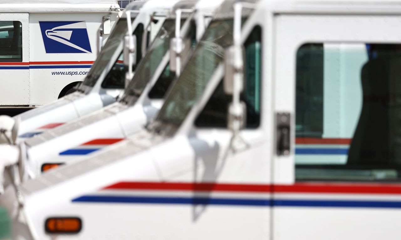 US Postal Service trucks are parked at a post office in Glendale, California.