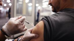 HUNTINGTON PARK-CA-AUGUST 28, 2024: Brandon Guerrero, 34, of Compton, receives both a flu and COVID-19 vaccine at CVS in Huntington Park on August 28, 2024. (Christina House / Los Angeles Times via Getty Images)