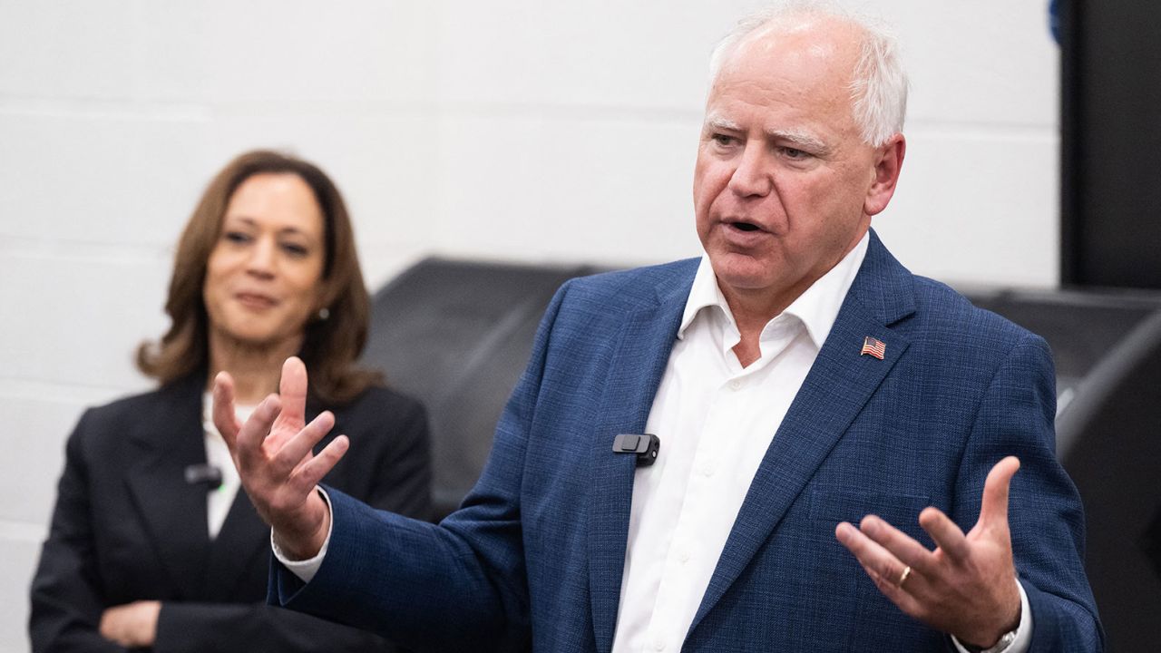 Democratic presidential candidate US Vice President Kamala Harris listen to her running mate, Governor Tim Walz, speak during a visit with members of the marching band at Liberty County High School in Hinesville, Georgia, August 28, 2024, as they travel across Georgia for a 2-day campaign bus tour. (Photo by SAUL LOEB / AFP) (Photo by SAUL LOEB/AFP via Getty Images)