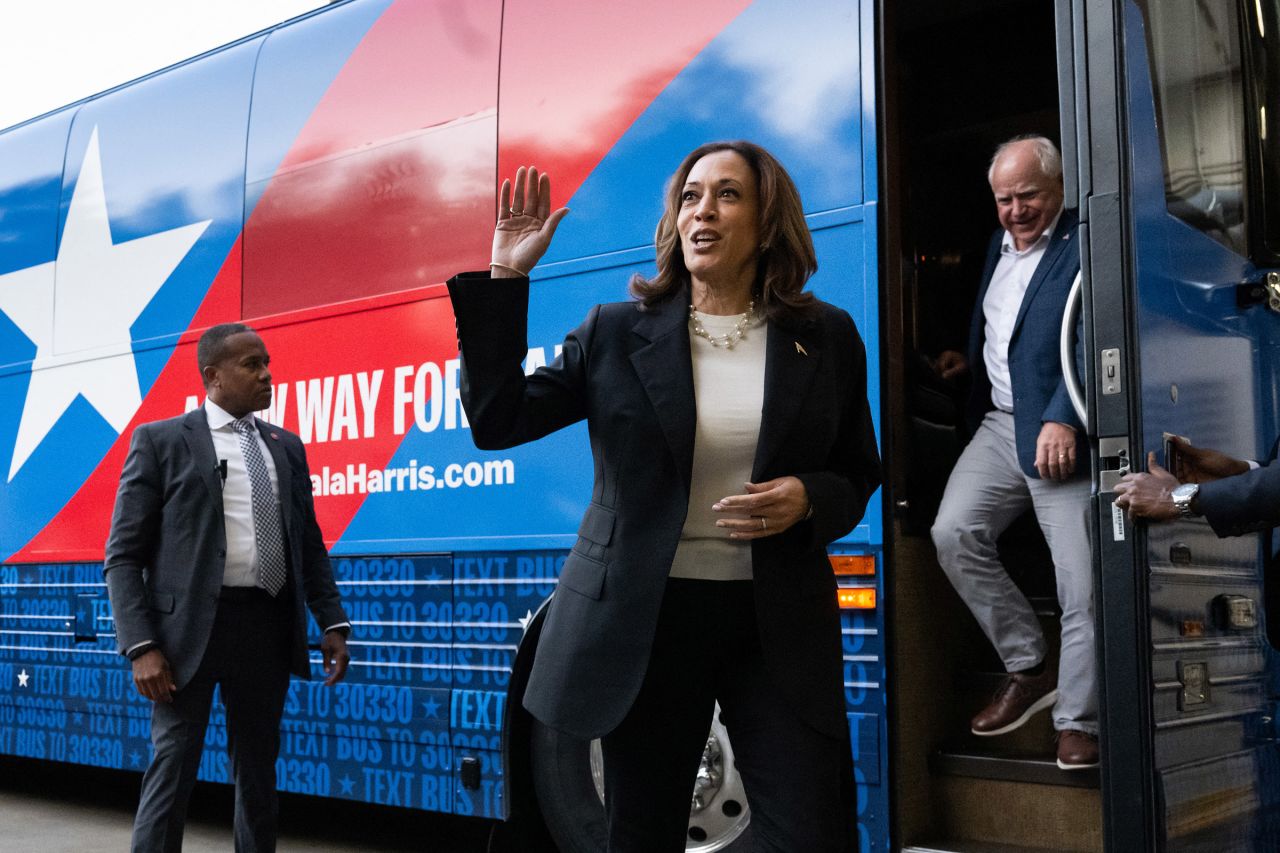 Vice President Kamala Harris and Minnesota Gov. Tim Walz disembark from their campaign bus in Savannah, Georgia, on August 28.