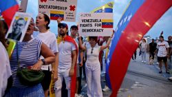 People hold Venezuelan flags and placards during a protest against Venezuelan President Nicolas Maduro and the results of the recent presidential election on the Brooklyn Bridge in New York on August 28, 2024. One month after a presidential vote it claims was stolen by incumbent Nicolas Maduro, Venezuela's opposition has called for mass rallies on August 28 to press for the recognition of its election "victory." (Photo by Leonardo Munoz / AFP) (Photo by LEONARDO MUNOZ/AFP via Getty Images)