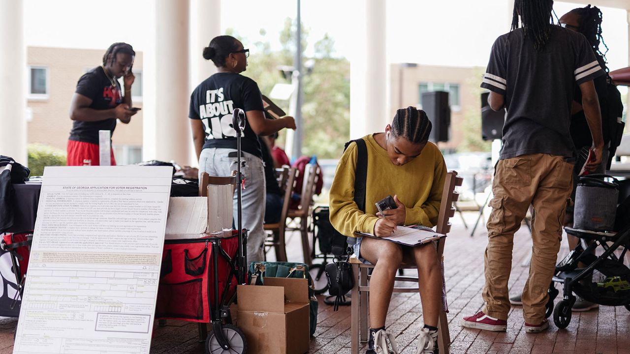 A Morehouse student fills out a voter registration form at a voter registration form at a voter registration booth at Morehouse College on August 19, 2024, in Atlanta, Georgia. Kamala Harris needs young, Black voters to have any hope of taking key battleground state Georgia, which became a focus for Donald Trump's efforts to overturn his 2020 US presidential defeat. (Photo by Elijah Nouvelage / AFP) (Photo by ELIJAH NOUVELAGE/AFP via Getty Images)