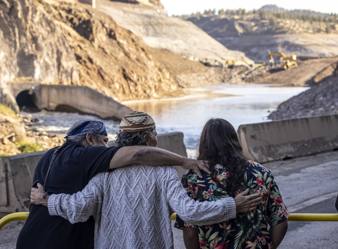 Tribal members hug as crews took down what was left of Iron Gate Dam on the Klamath River. A coalition of tribes, local and state authorities joined to make the years-long project a reality.