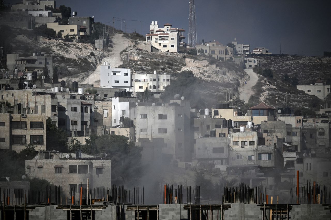 Smoke rises among buildings during an Israeli army raid in Jenin in the occupied West Bank on August 30, 2024. An Israeli air strike hit the occupied West Bank as its large-scale military operation entered a third day, with the military killing at least 16 Palestinians. (Photo by RONALDO SCHEMIDT / AFP) (Photo by RONALDO SCHEMIDT/AFP via Getty Images)