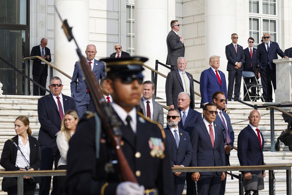 Former President Donald Trump observes a changing of the guard at the Tomb of the Unknown Soldier alongside Arlington National Cemetery Deputy Chief of Staff Bob Quackenbush at the Arlington National Cemetery on August 26, 2024 in Arlington, Virginia.