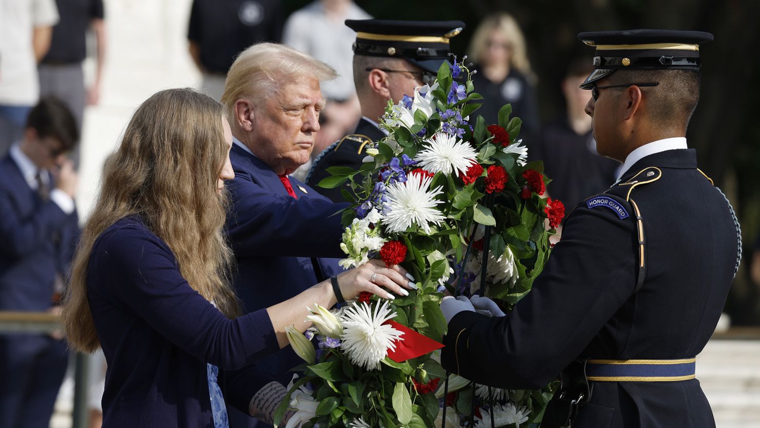 Former U.S. President Donald Trump stands alongside Misty Fuoco, whose sister Sgt. Nicole Gee died in Abbey Gate Bombing, at a wreath laying ceremony at the Tomb of the Unknown Soldier at Arlington National Cemetery on August 26, 2024 in Arlington, Virginia.