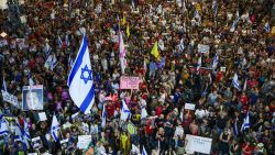 Demonstrators lift placards and flags during a protest calling for the release of Israelis held hostage by Palestinian militants in Gaza since October, in Tel Aviv on August 31, 2024, amid the ongoing conflict in the Gaza Strip between Israel and the Palestinian militant Hamas movement. (Photo by Jack GUEZ / AFP) (Photo by JACK GUEZ/AFP via Getty Images)