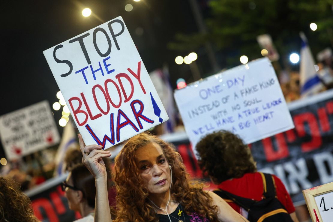 Demonstrators lift placards and flags during a protest calling for the release of Israelis held hostage by Hamas militants, in Tel Aviv, Israel on August 31, 2024.