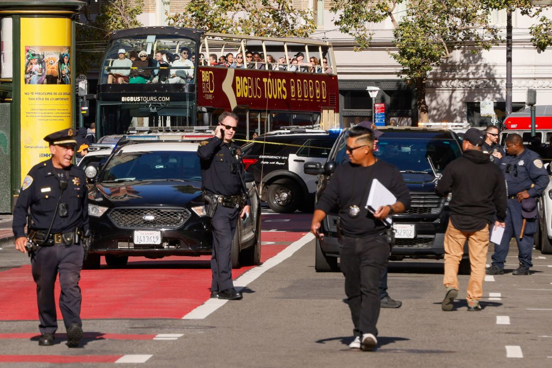 Police officers secure the area and investigate the scene of a shooting in Union Square in San Francisco on Saturday.