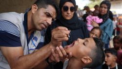 TOPSHOT - A health worker administers the Polio vaccine to a Palestinian child in Zawayda in the central Gaza Strip on September 1, 2024, amid the ongoing conflict between Israel and the militant group Hamas. The World Health Organization said Israel had agreed to at least three days of "humanitarian pauses" in parts of Gaza, starting on August 31, to facilitate a vaccination drive after the territory recorded its first case of polio in a quarter of a century. (Photo by Eyad BABA / AFP) (Photo by EYAD BABA/AFP via Getty Images)