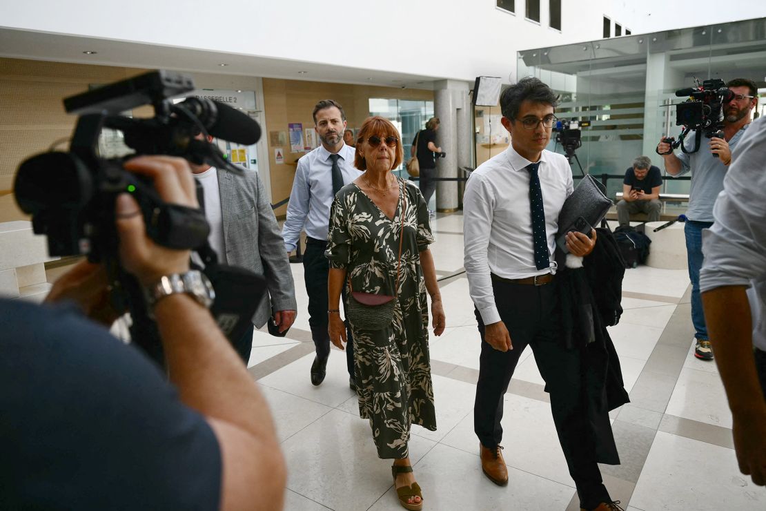 Gisele, center, flanked by her lawyer Stephane Babonneau, arrives at the courthouse during the trial of her husband accused of drugging her for nearly ten years and inviting strangers to rape her at their home in the south of France, on September 2, 2024.