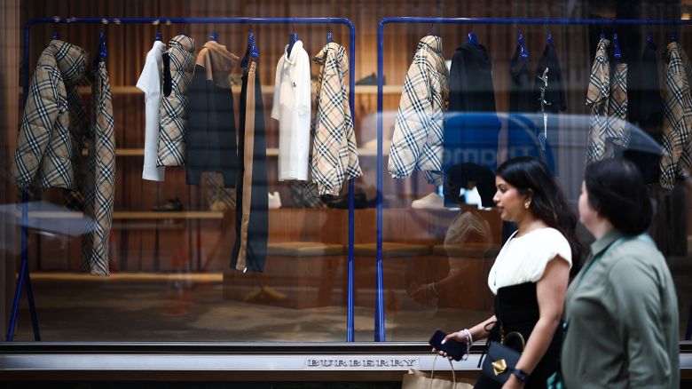 Pedestrians walk past the window display of the store of British fashion label Burberry, in central London, on September 2, 2024. Burberry may lose its spot in the upcoming FTSE 100 reshuffle, according to the London Stock Exchange Group (LSEG)'s indicative quarterly review changes for September 2024. The actual review for all FTSE UK indices will be done on 3 September, with final changes being revealed on 4 September, following market close. (Photo by HENRY NICHOLLS / AFP) (Photo by HENRY NICHOLLS/AFP via Getty Images)
