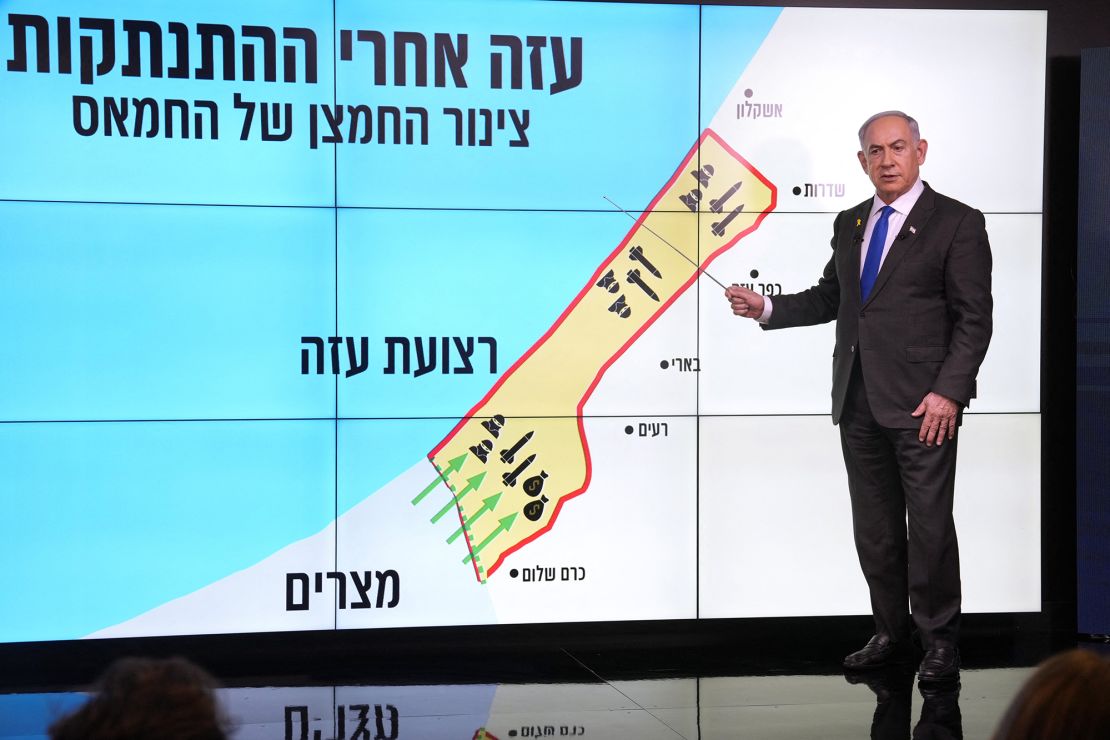 Netanyahu stands before a map of Gaza during a news conference in Jerusalem on Monday.