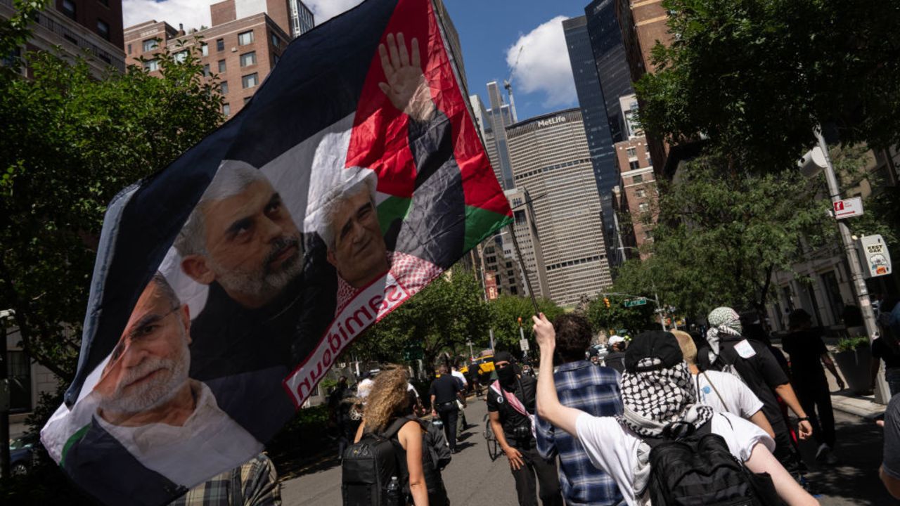 NEW YORK, NEW YORK - SEPTEMBER 2: A person holds a flag with an image of Yahya Sinwar as people attend a protest in support of the war in Gaza, on Labor Day on September 2, 2024 in New York City. Following the deaths of six hostages in Gaza, protestors demand that Israel reach a deal with Hamas. (Photo by Adam Gray/Getty Images)