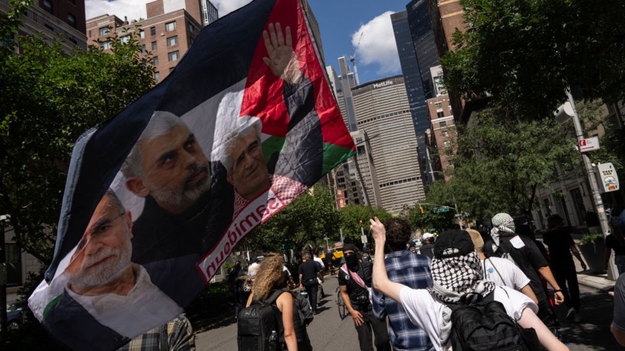 NEW YORK, NEW YORK - SEPTEMBER 2: A person holds a flag with an image of Yahya Sinwar as people attend a protest in of the war in Gaza, on Labor Day on September 2, 2024 in New York City. Following the deaths of six hostages in Gaza, protestors demand that Israel reach a deal with Hamas. (Photo by Adam Gray/Getty Images)