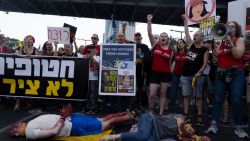 TEL AVIV, ISRAEL - SEPTEMBER 2: Protesters stage as hostages during a rally on the second day of demonstrations demanding a Gaza deal  on September 2, 2024 in Tel Aviv, Israel. After the bodies of six Israeli kidnap victims were recovered from tunnels beneath Gaza at the weekend, the Hostages and Missing Families Forum supported protests in Jerusalem and Tel Aviv demanding that Netanyahu justies the delay in signing the ceasefire deal due to the addition of new conditions. (Photo by Amir Levy/Getty Images)