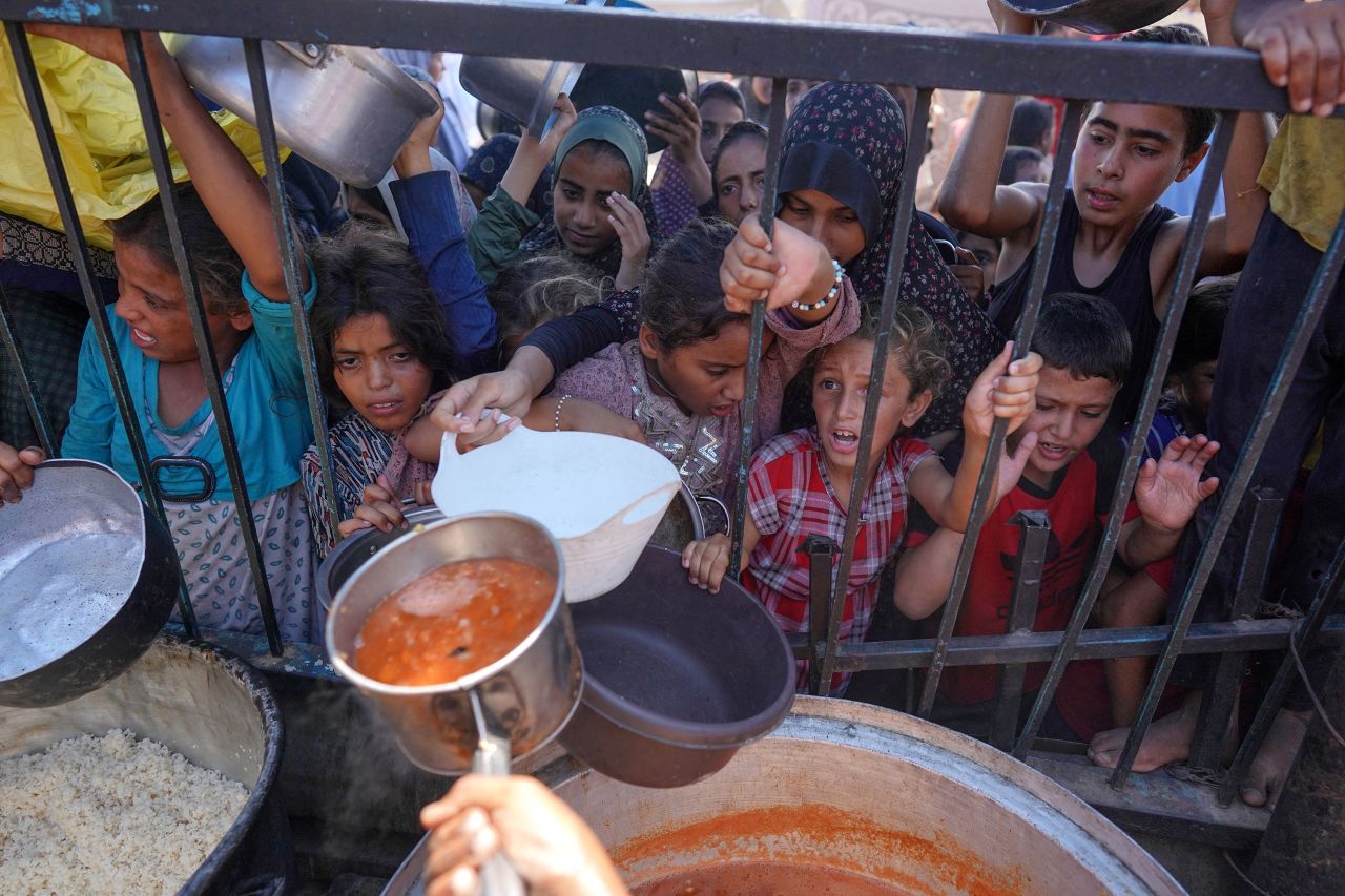 Palestinians receive food at a displacement camp in Khan Younis, Gaza, on September 3.