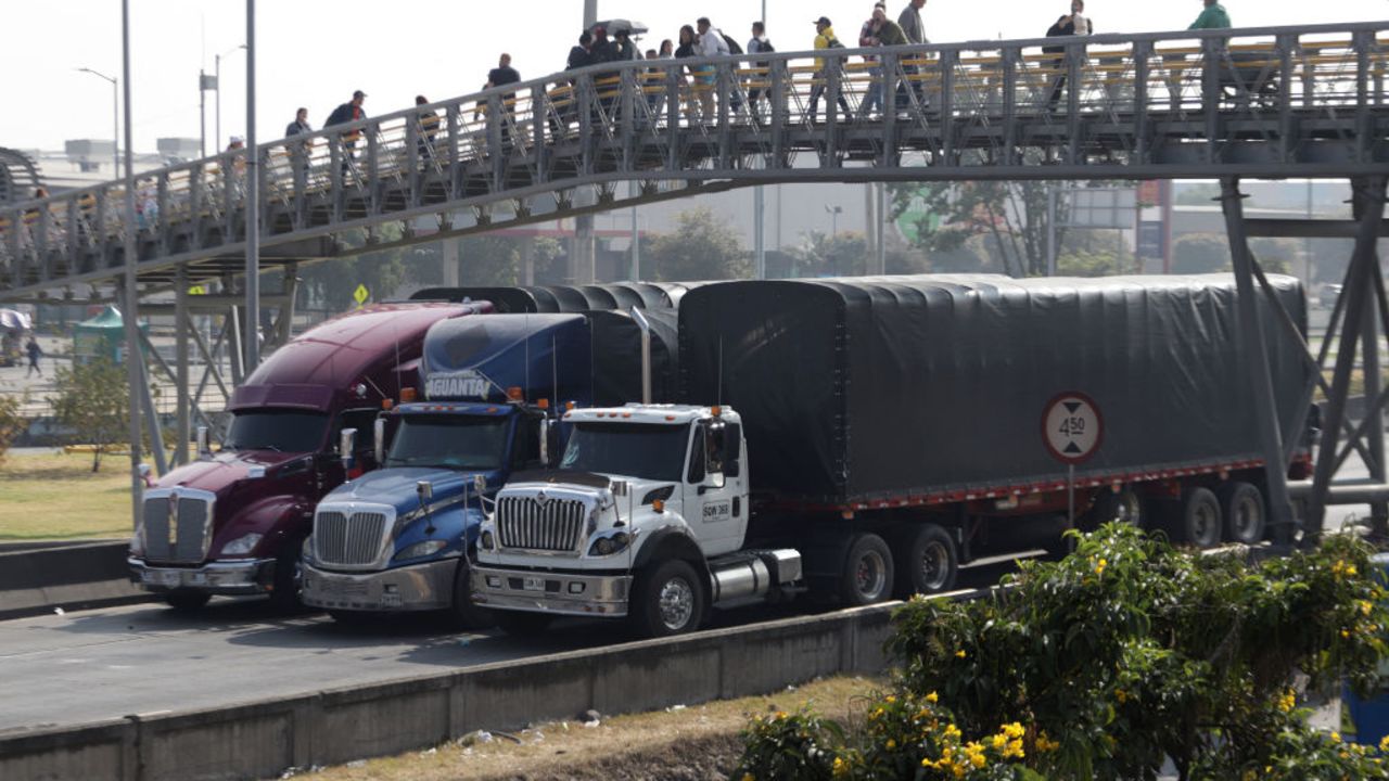 TOPSHOT - Truck drivers block a street in Bogota on September 4, 2024, to protest against the rise in the price of a subsidized gallon of diesel, which has risen by the equivalent of 46 cents on the dollar. (Photo by Andrea ARIZA / AFP) (Photo by ANDREA ARIZA/AFP via Getty Images)