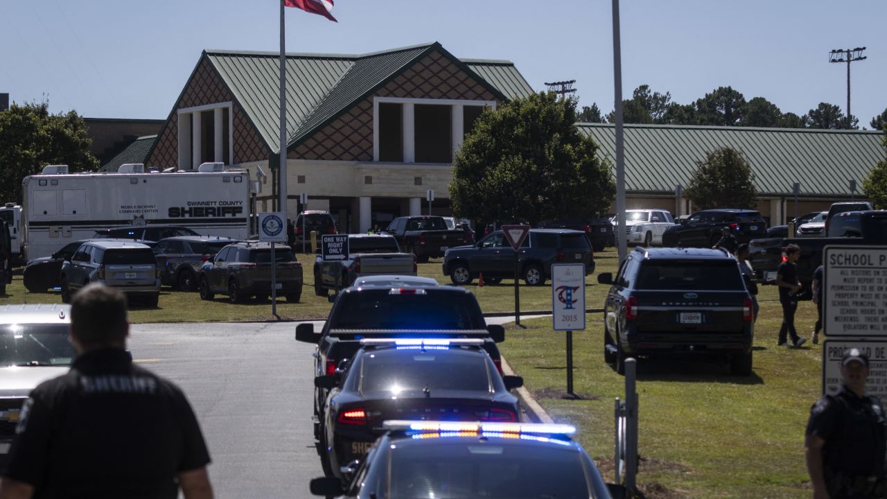 Law enforcement and first responders assess the situation at Apalachee High School in Winder, Georgia, on September 4, 2024, after a shooting was reported. Police took a suspect into custody after the shooting on Wednesday, with students evacuated from the scene and local media reporting fatalities. CNN, citing unnamed law enforcement sources, reported that four people had been killed and 30 wounded. Other outlets reported two deaths. (Photo by CHRISTIAN MONTERROSA / AFP) (Photo by CHRISTIAN MONTERROSA/AFP via Getty Images)