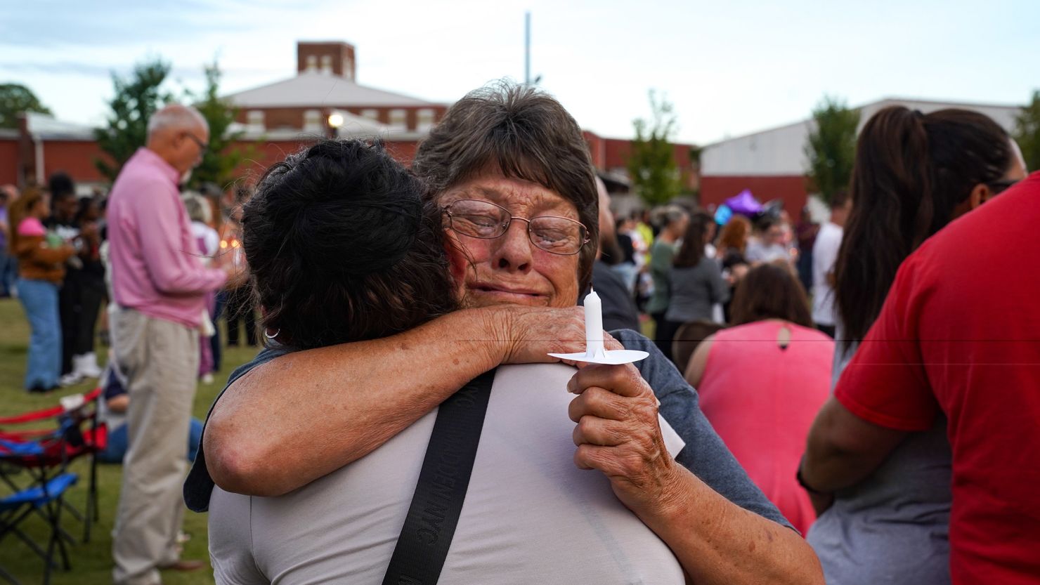 Two women embrace as students, faculty and community members gather Wednesday for a vigil after a shooting at Apalachee High School in Winder, Georgia.