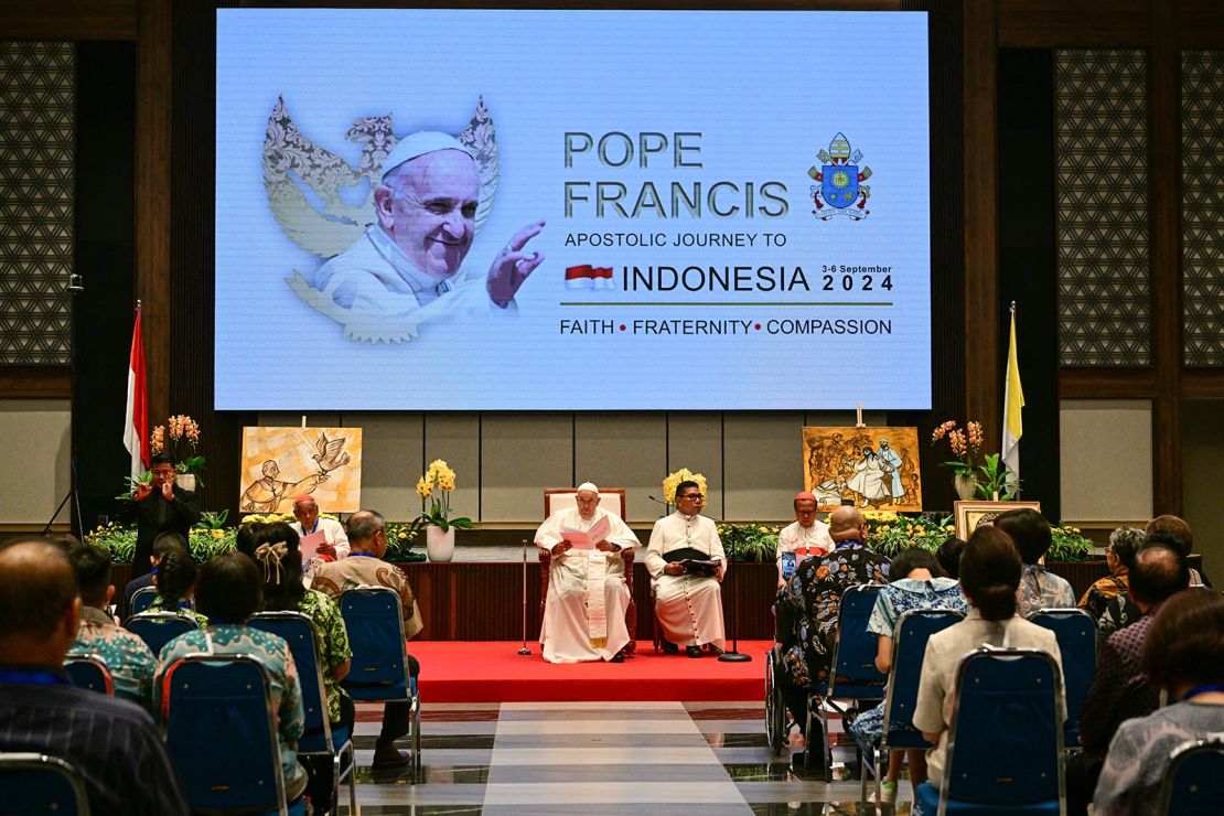 Pope Francis (C) attends an event with beneficiaries of charity organisations at the Bishops' Conference of Indonesia (KWI) office in Jakarta on September 5, 2024.