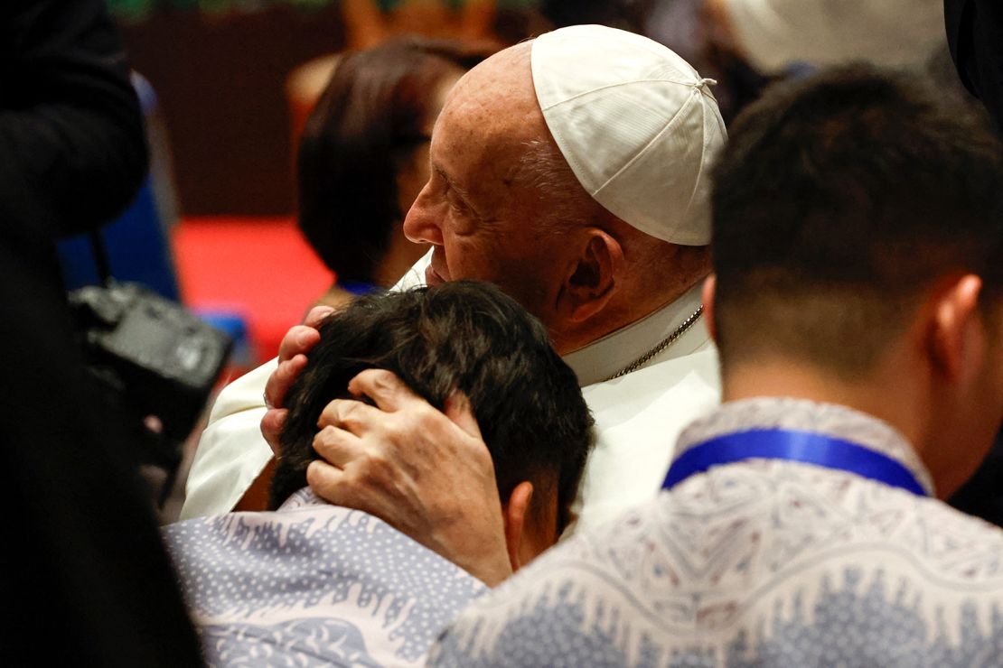 Pope Francis embraces a person on the day he attends a meeting with beneficiaries from charitable organizations, during his apostolic visit to Asia, at Indonesian Bishops' Conference headquarters in Jakarta on September 5, 2024.