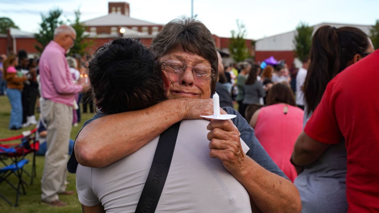 WINDER, GEORGIA - SEPTEMBER 4: (EDITOR'S NOTE: retransmission of image for improved quality) Two women embrace as students, faculty and community members gather for a vigil after a school shooting took place on September 4, 2024 in Winder, Georgia. Multiple fatalities and injuries have been reported and a suspect is in custody according to authorities.(Photo by Megan Varner/Getty Images)