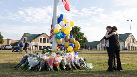 WINDER, GEORGIA - SEPTEMBER 5: Students embrace near a makeshift memorial at Apalachee High School on September 5, 2024 in Winder, Georgia. Two students and two teachers were shot and killed at the school on September 4, and a 14-year-old suspect, who is a student at the school, is in custody. (Photo by Jessica McGowan/Getty Images)