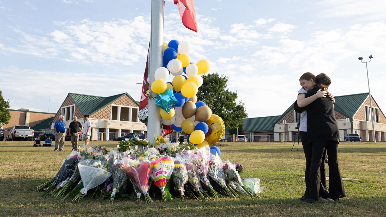 Students embrace near a makeshift memorial at Apalachee High School on September 5 in Winder, Georgia.