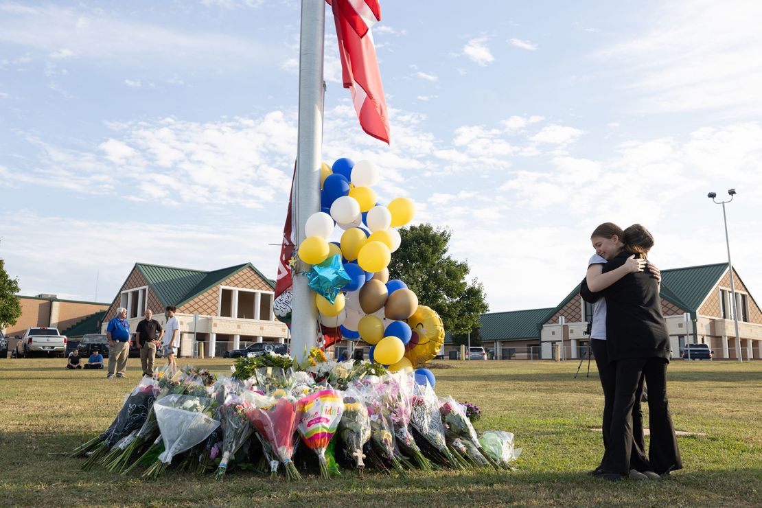 Students embrace at makeshift memorial at Apalachee High School in September 2024.