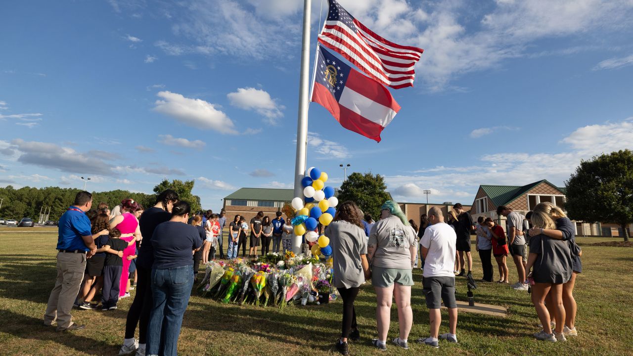 Students and community members make a prayer circle around a makeshift memorial outside Apalachee High School on September 5, 2024, in Winder, Georgia.