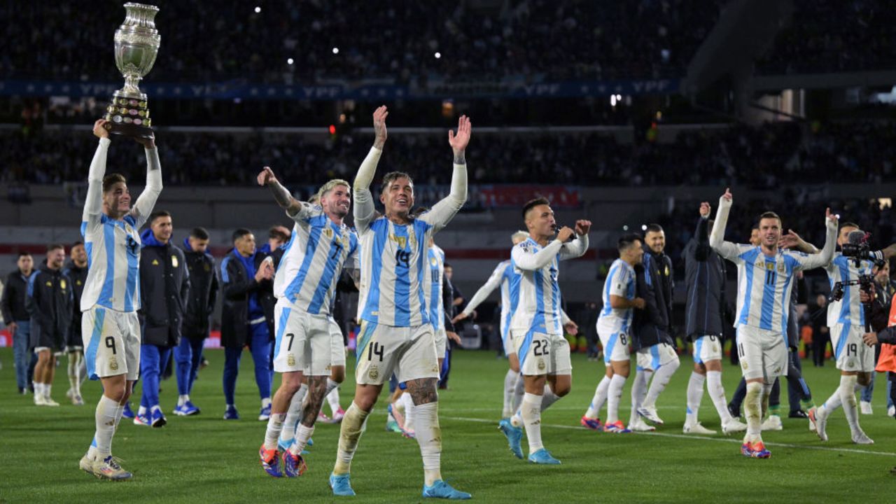 Argentina players celebrate their victory with a replica of the Copa America trophy at the end of the 2026 FIFA World Cup South American qualifiers football match between Argentina and Chile at the Mas Monumental stadium in Buenos Aires on September 5, 2024. (Photo by JUAN MABROMATA / AFP) (Photo by JUAN MABROMATA/AFP via Getty Images)