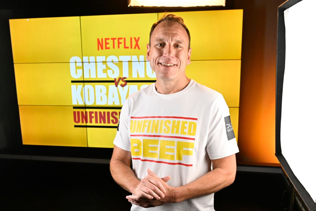 Joey Chestnut breaks his own world record by eating 83 hot dogs and buns during a Netflix competition on Monday.