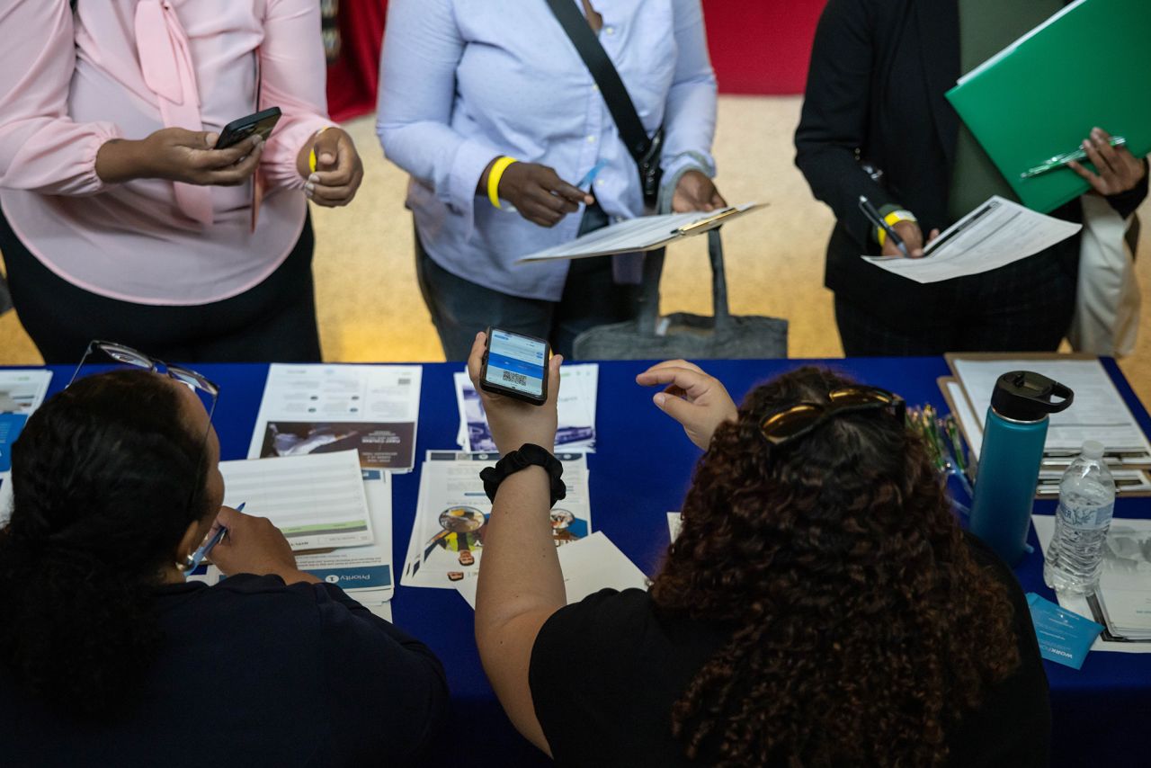 Jobseekers talk to recruiters during the New York Public Library's annual Bronx Job Fair & Expo at the Bronx Library Center in New York on Friday, September 6.