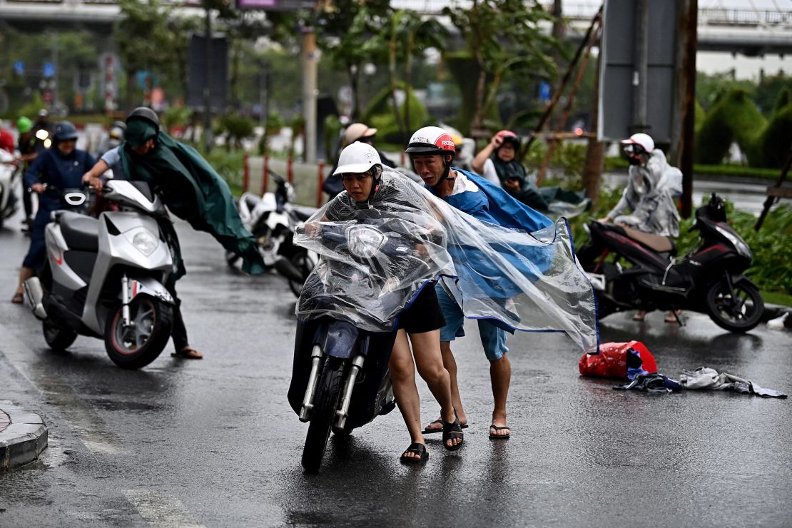 Motorcyclists struggle from the strong wind of Typhoon Yagi in Hai Phong, Vietnam on September 7, 2024.