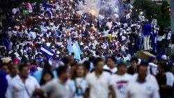 People take part in a march against the government of Honduran President Xiomara Castro in Tegucigalpa on September 6, 2024. Thousands of right-wing opponents marched Friday with torches in Honduras against the government of leftist Xiomara Castro for canceling the extradition treaty with the United States that allowed the imprisonment of fifty drug traffickers. (Photo by STRINGER / AFP) (Photo by STRINGER/AFP via Getty Images)