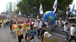 Members of South Korean environment groups march during a rally against climate change at the Gangnam district in Seoul on September 7, 2024. (Photo by Jung Yeon-je / AFP) (Photo by JUNG YEON-JE/AFP via Getty Images)