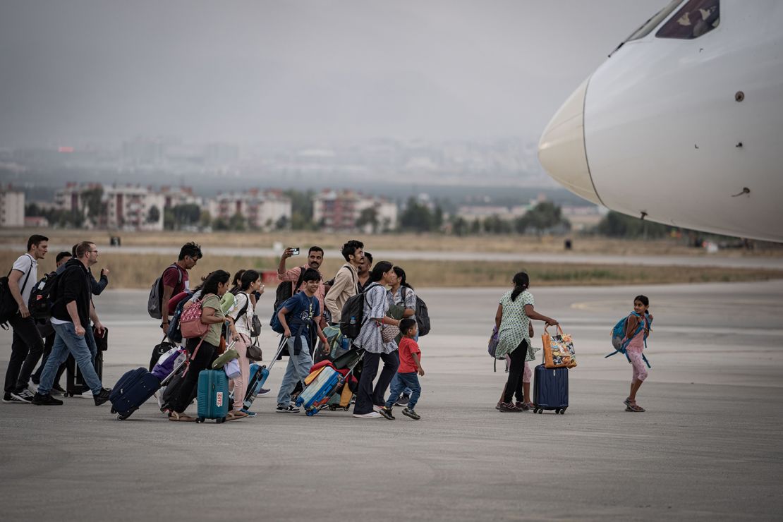 Passengers board another plane that arrived in Turkey after their Vistara Airlines flight from India to Germany made an emergency landing at Erzurum Airport due to a bomb threat on September 7, 2024.