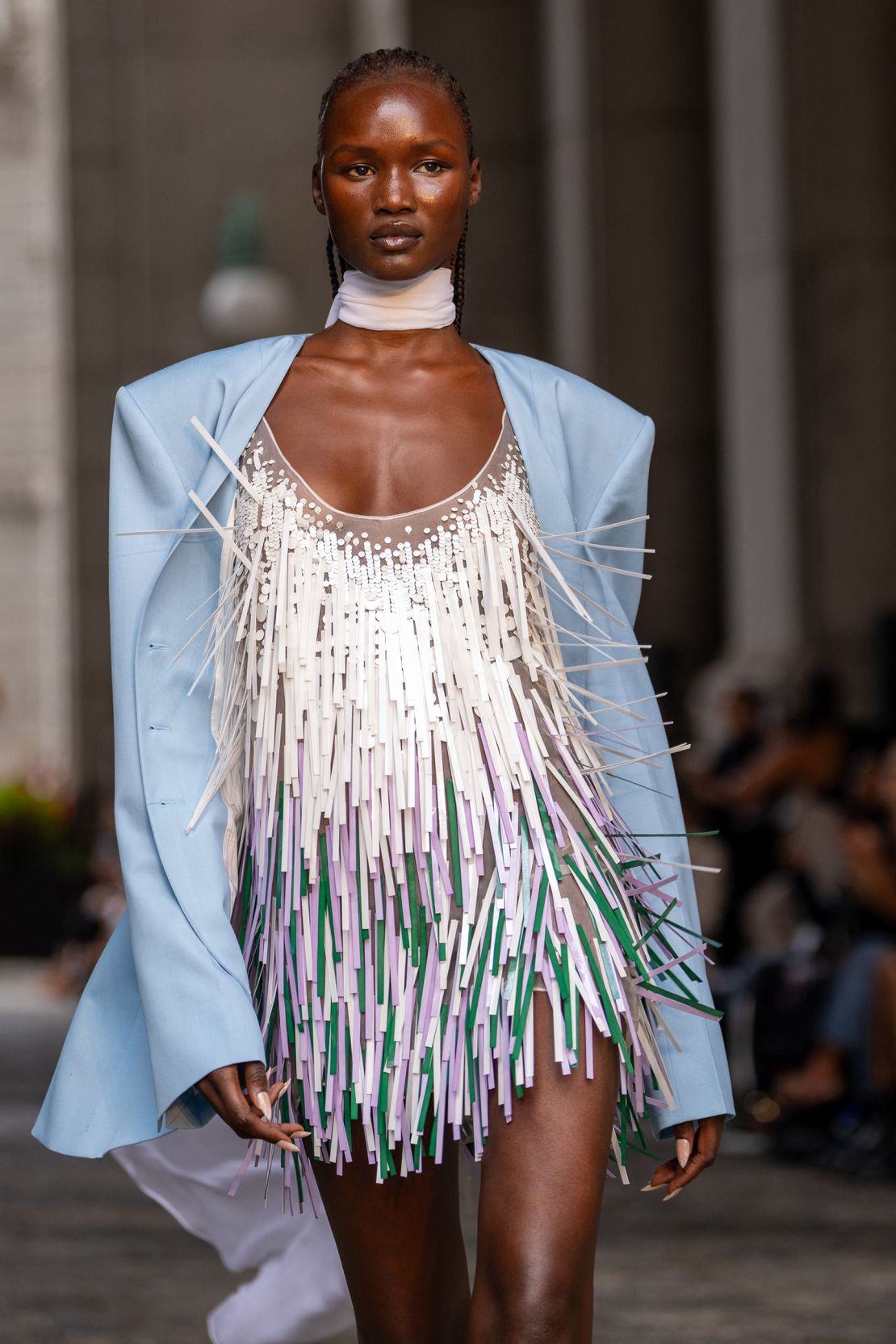 A powder blue sherwani-style jacket and mini dress made of multi-colored mylar strips.