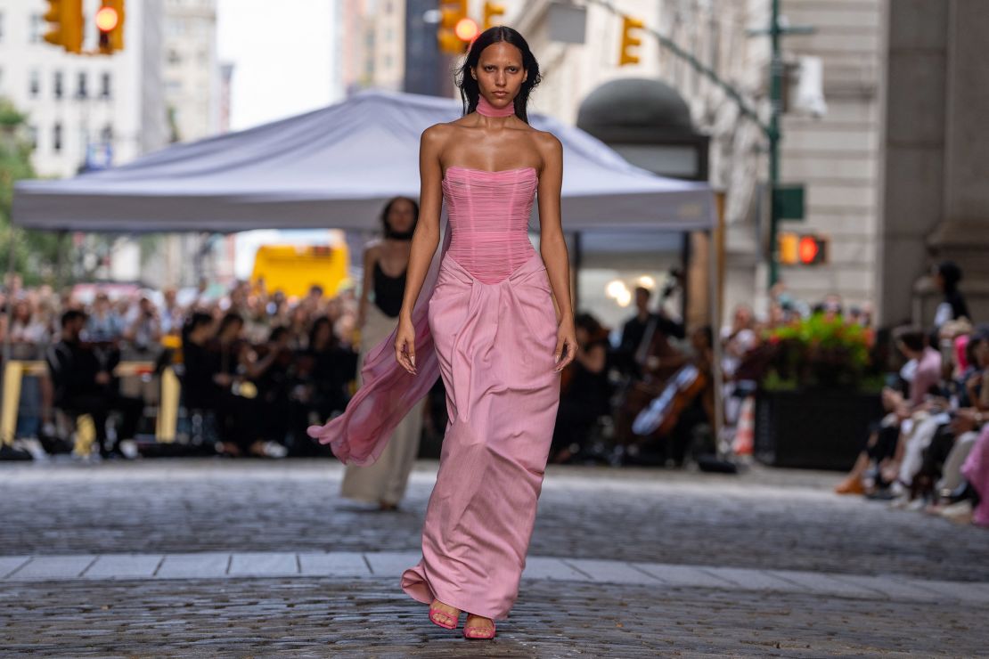 As a nod to Holi, the colour pink can be found throughout the collection, from this draped look to the finale where models sprinkled pink powder into the wind.