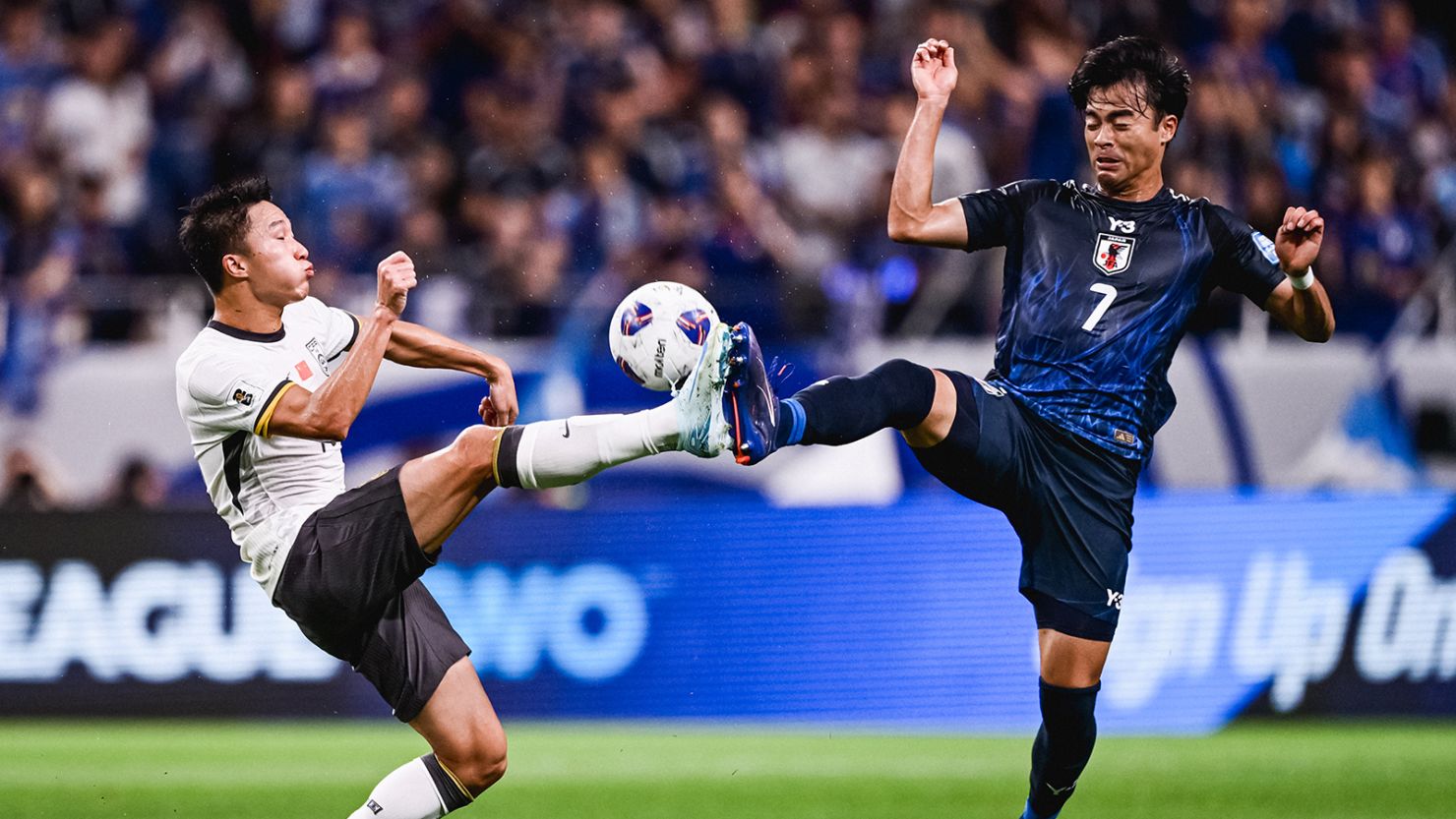 Yang Zexiang of Team China and Kaoru Mitoma of Team Japan compete for the ball during the 2026 FIFA World Cup Qualifier match between China and Japan at Saitama Stadium on September 5, 2024.