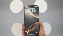 A specialist holds up an iPhone 16 Pro Max following Apple's "It's Glowtime" event in Cupertino, California, September 9, 2024. (Photo by Nic COURY / AFP) (Photo by NIC COURY/AFP via Getty Images)