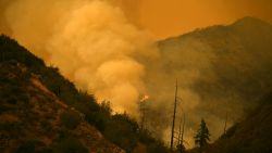 Smoke billows as the Line Fire burns off of Highway 38, north of Yucaipa, California on September 9, 2024. Wildfires fueled by soaring temperatures in the western United States have scorched thousands of acres, forcing hundreds of families to flee, US officials said September 9, 2024. A blaze burning out of a control near Los Angeles sparked mandatory evacuations as it tore through swathes of tinder-dry California countryside around popular tourist spots. The so-called Line Fire erupted on Thursday to the east of the city and exploded over the weekend, consuming more than 20,000 acres (8,000 hectares) and threatening tens of thousands of homes and other buildings. (Photo by Patrick T. Fallon / AFP) (Photo by PATRICK T. FALLON/AFP via Getty Images)