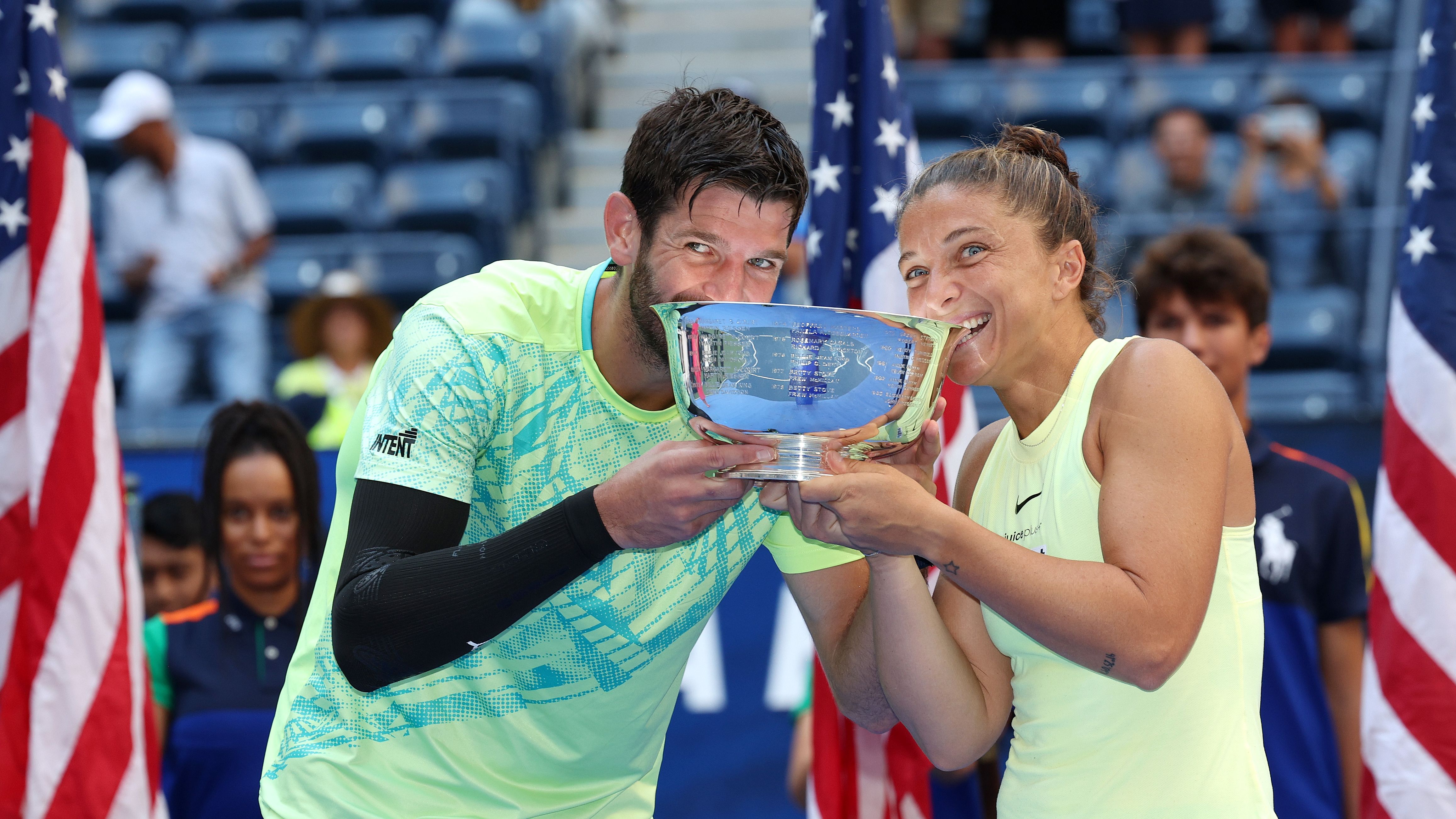 NEW YORK, NEW YORK - SEPTEMBER 05: Sara Errani (R) and Andrea Vavassori (L) of Italy bit their trophy after defeating Taylor Townsend and Donald Young of the United States in their Mixed Doubles Final match on Day Eleven of the 2024 US Open at USTA Billie Jean King National Tennis Center on September 05, 2024 in the Flushing neighborhood of the Queens borough of New York City. (Photo by Jamie Squire/Getty Images)